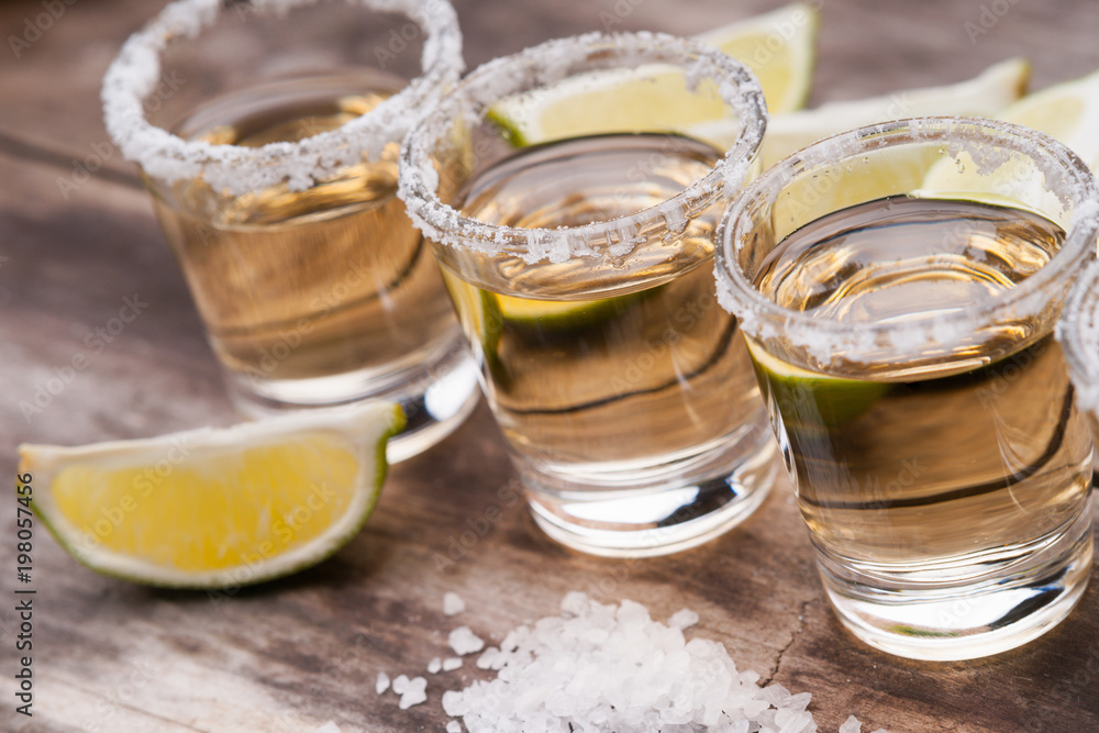 Tequila shots with lime fruits and salt Tequila shots with lime fruits and salt
