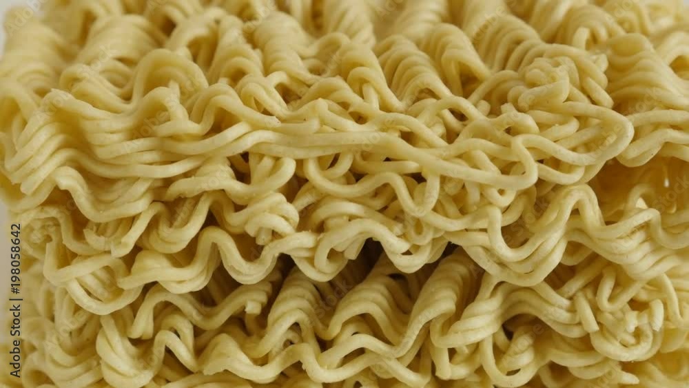 Close-up of instant Chinese noodles on white background footage - Uncooked Chinese noodles on white background slow tilt Close-up of instant Chinese noodles on white background footage - Uncooked Chinese noodles on white background slow tilt