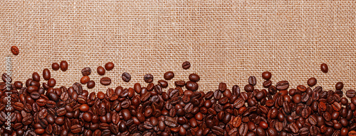 Panoramic snapshot of coffee beans on the background of sack cloth