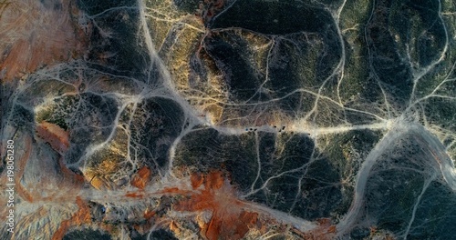 Aerial drone view on a mountainous landscape with a network of hiking paths creating amazing pattern. Zhangye danxia landform geological park in Gansu province, China.