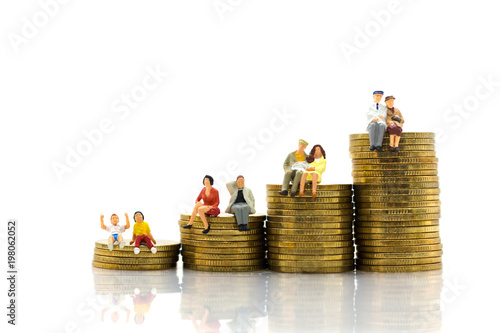 Miniature people: Group couple figure sitting on top of stack coins. Image use for retirement planning, Life insurance concept.