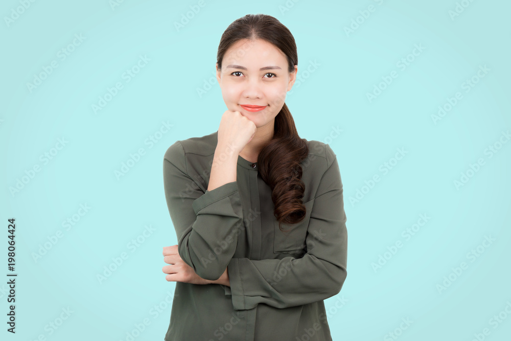 Portrait of Happy attractive fashion young Asian woman in green casual wear with smiling and standing on a blue pastel background. Portrait of Happy attractive fashion young Asian woman in green casual wear with smiling and standing on a blue pastel background.