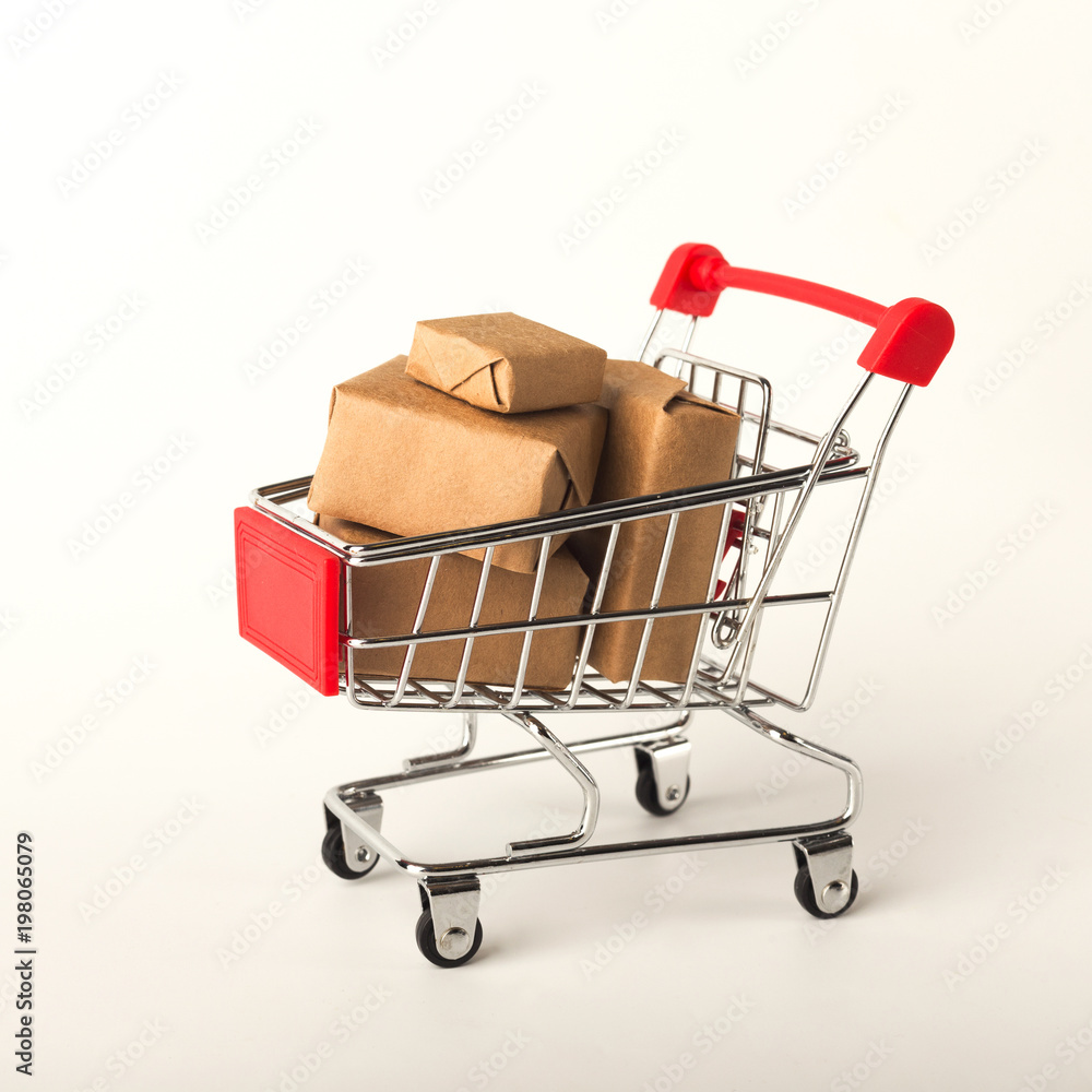 Miniature shopping cart and parcels isolated