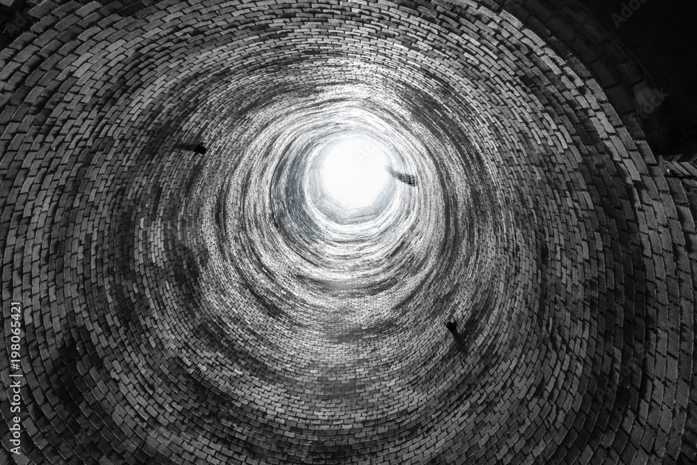 Abstract image looking up an abandoned brick smoke stack. Round circle  repeating pattern of old bricks, and light at the end Stock Photo | Adobe  Stock