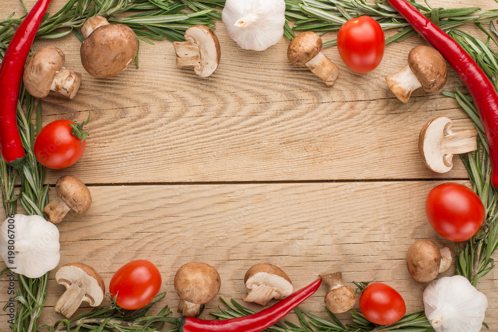 Vegetables with mushrooms on a wooden texture. A view from above, with an empty place for an inscription or an advertisement. Vegetables with mushrooms on a wooden texture. A view from above, with an empty place for an inscription or an advertisement.