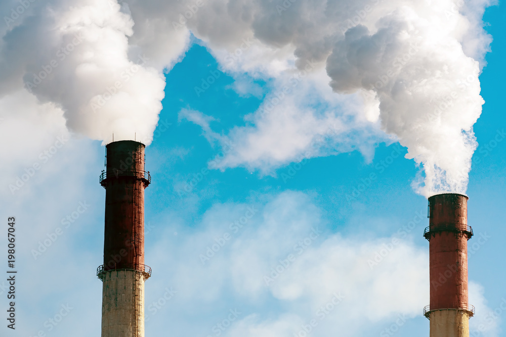 Smoke from factory pipes against the blue sky Smoke from factory pipes against the blue sky