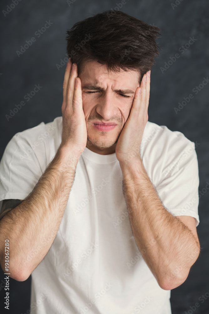 Young stressed man cover his face with hands Young stressed man cover his face with hands