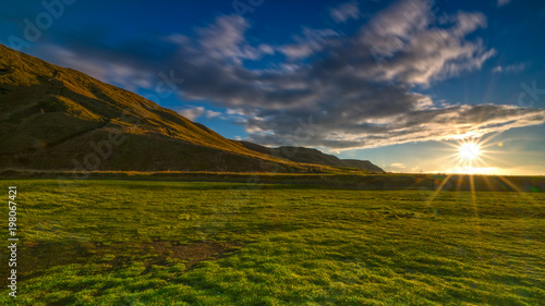 Green grass meadow in iceland with early morning shining at horizontal © LeeSensei