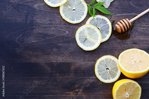 On a wooden texture background a lemon and honey