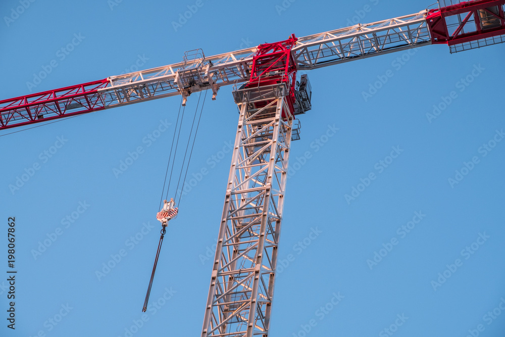 Crane ready for construction work in the winter morning light with blue sky as background