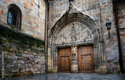 amazing old medieval architecture with wooden door in cathedral of Bilbao. Spain.