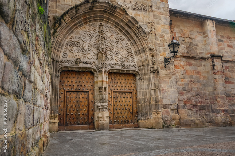 amazing old medieval architecture with wooden door in cathedral in Spain.