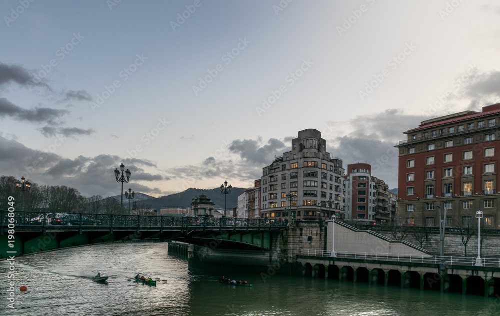 kayaks in the river at sunset in the city of bilbao. Spain