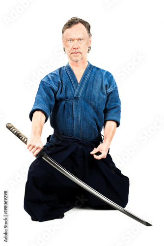 Caucasian male training Iaido, japanese sword sport. Sitting position.