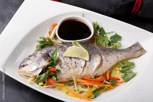 Whole steamed dorado fish