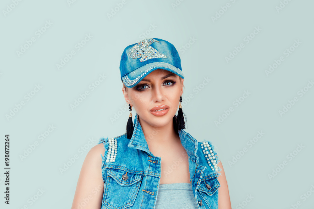 woman in jeans hat and jacket slightly smiling woman in jeans hat and jacket slightly smiling