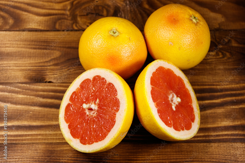 Ripe fresh grapefruits on wooden table Ripe fresh grapefruits on wooden table
