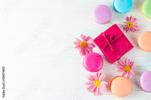 Photo of cake macarons, gift box, tea, coffee, cappuccino and flowers. Sweet romantic food macaroon concept. Morning breakfast and presents. Valentine's day concept. © jeny_lk