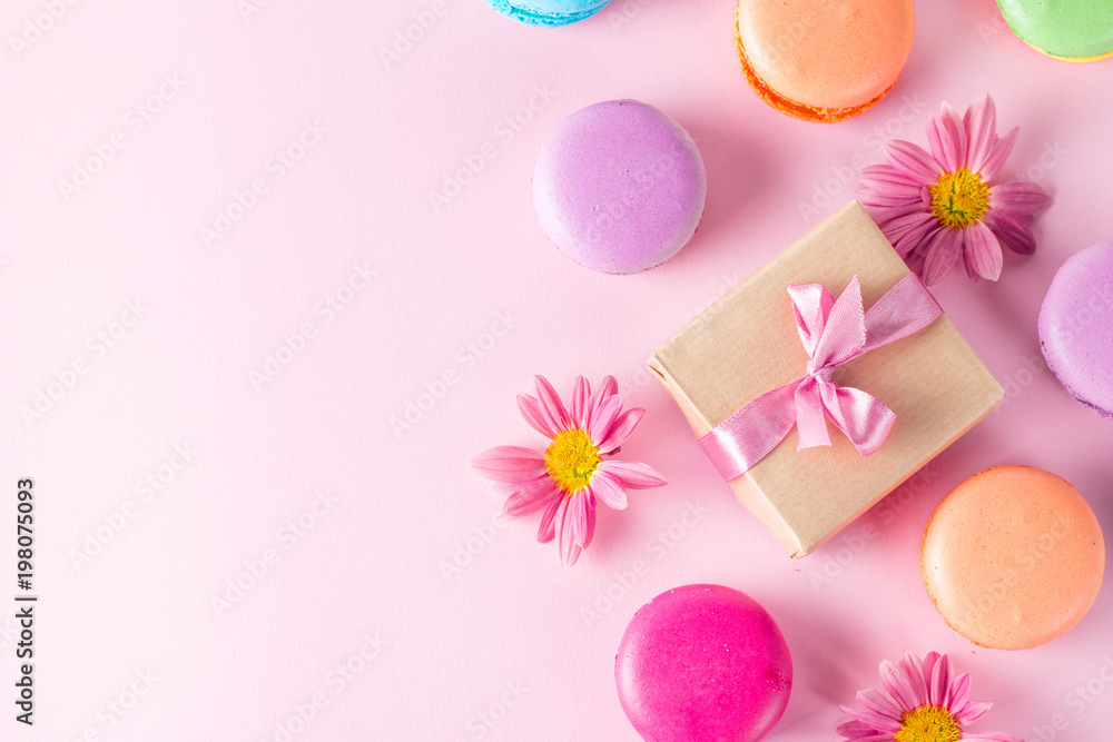 Photo of cake macarons, gift box, tea, coffee, cappuccino and flowers. Sweet romantic food macaroon concept. Morning breakfast and presents. Valentine's day concept.