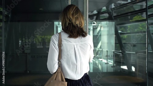 Young businesswoman entering office, super slow motion 120fps
