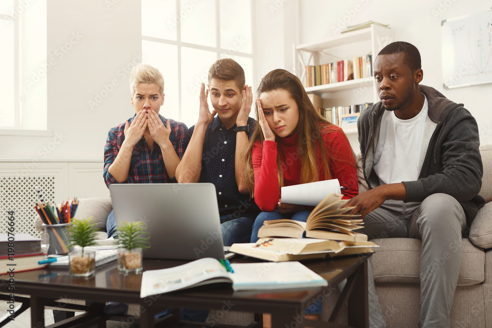 Fototapeta premium Group of diverse students studying at home atmosphere on the couch