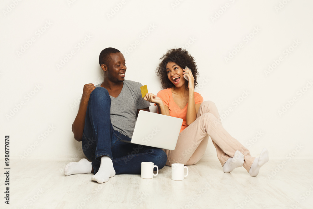 Happy african-american couple shopping online Happy african-american couple shopping online