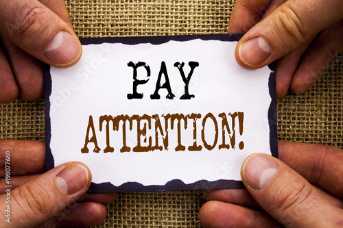 Word, writing, text  Pay Attention. Conceptual photo Be Careful Beware Mindful Alarm written on Sticky Note Paper Holding Hand with Finger.