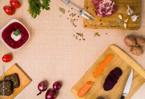 Borscht. Red soup in bowl with sour cream, isolated on wooden background. Close-up. Top view, vegetable, vegetarian, vintage, copyspace photo