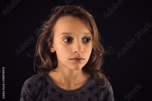 Portrait of sad girl on a black background