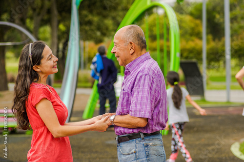 Outdoor view of daughter and father holding their hands at outdoors in the park