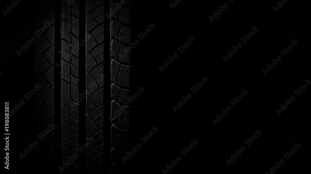Naklejka premium new tire texture in the dark for background