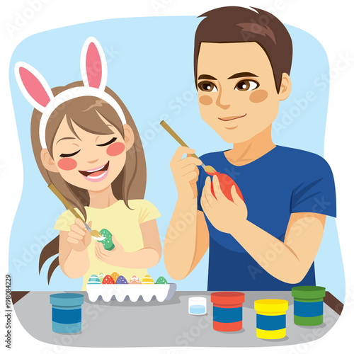 Happy family of father and daughter painting easter eggs 