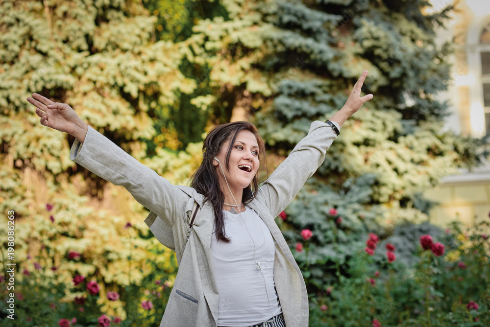 Happy carefree woman tourist with outstretched hands in the city Happy carefree woman tourist with outstretched hands in the city