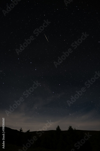 Shooting star of the annual star shower Perseids, taken in Austria in high format