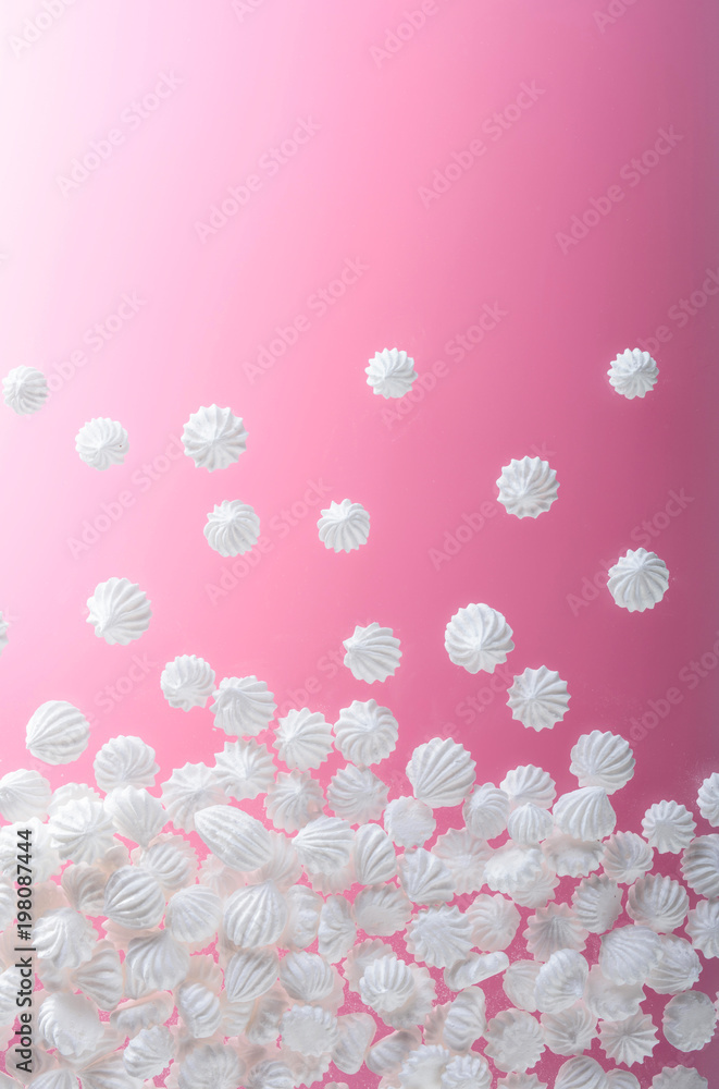 French vanilla meringue cookies on pink background with copy space.