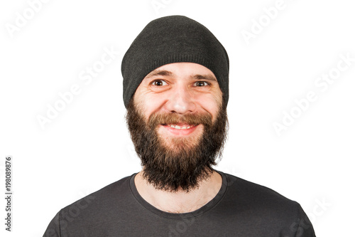 Young bearded guy in hat, smiles. Isolated on white.