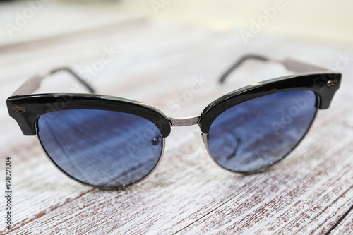  Women's stylish sunglasses on white wooden background