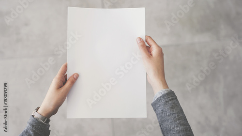 Person holding white empty paper photo
