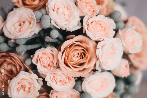 Bridal morning details. Wedding bouquet of orange  beige and pink flowers with succulent