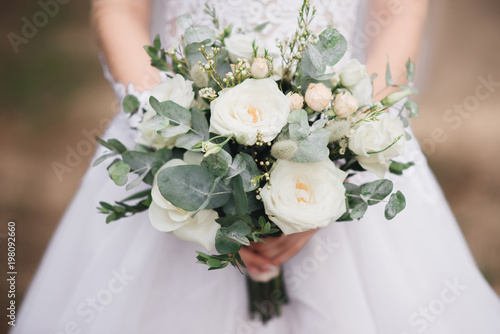 Bridal morning details. Wedding bouquet in the hands of the bride, selectoin focus photo