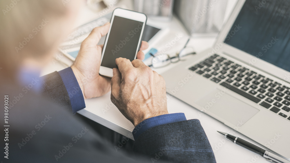 Businessman using mobile phone in office Businessman using mobile phone in office