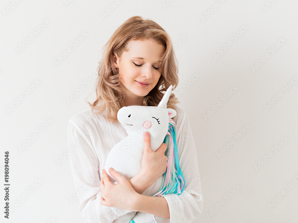 Young pretty woman with unicorn toy Young pretty woman with unicorn toy