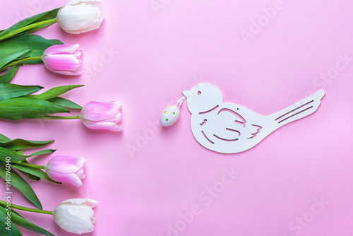 Bouquet tulips and easter decor on wooden background.Easter holiday concept. 
