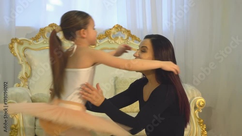 mom ballerina hugs her daughter ballerina