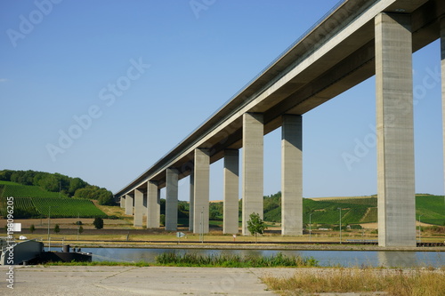 concrete highway bridge across a river valley in Germany under blue sky
