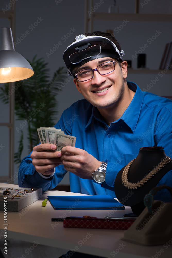 Jeweler working in his workshop late at night Jeweler working in his workshop late at night