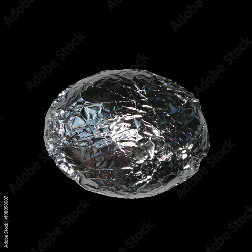 Silver egg on a black background.Egg covered with crumpled foil