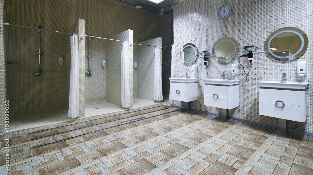 Defilé vergelijking spijsvertering Public shower interior with everal showers, toilet sink and lockers in  locker room in luxury fitness spa centre Stock Photo | Adobe Stock
