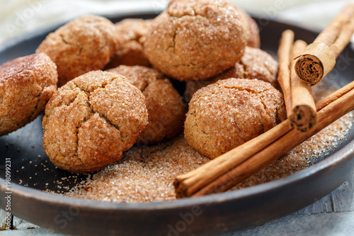Cookies with cinnamon sugar on a wooden platter.