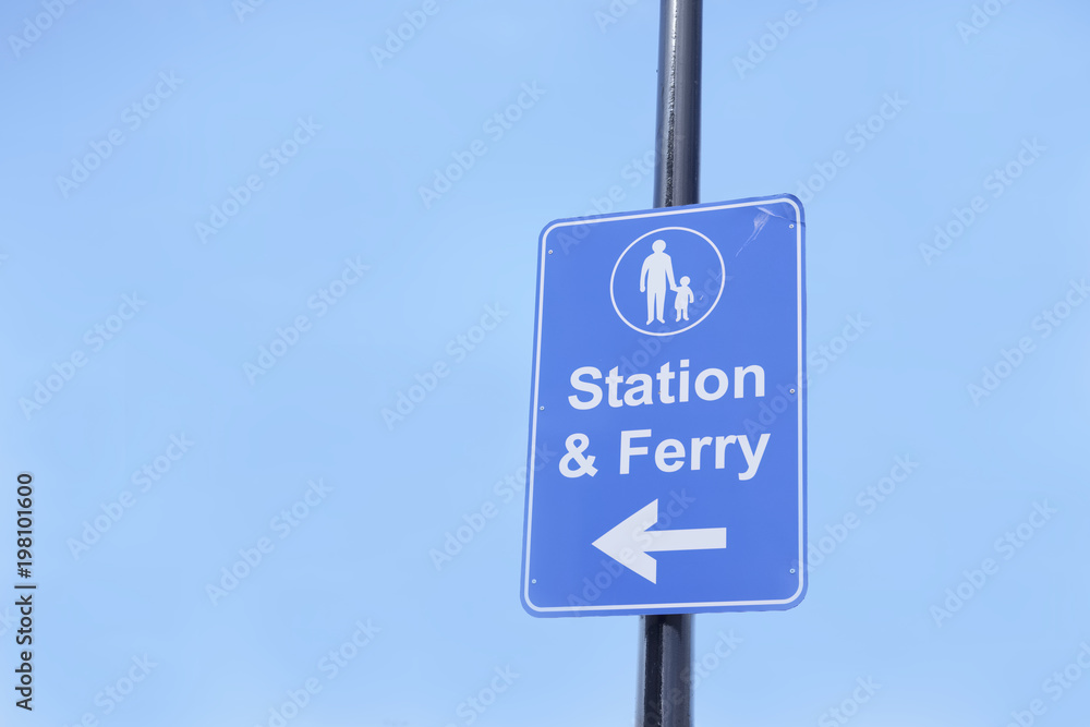 Station and ferry direction sign post large blank blue sky background Station and ferry direction sign post large blank blue sky background